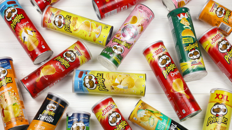 Various cans of Pringles arranged on a white background