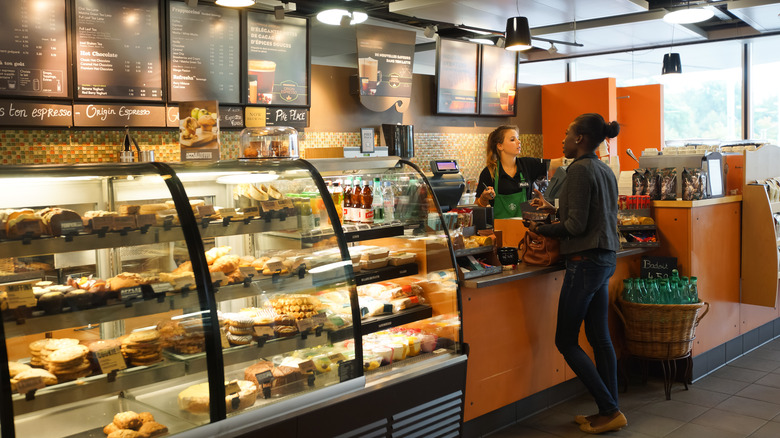 Person ordering at Starbucks counter