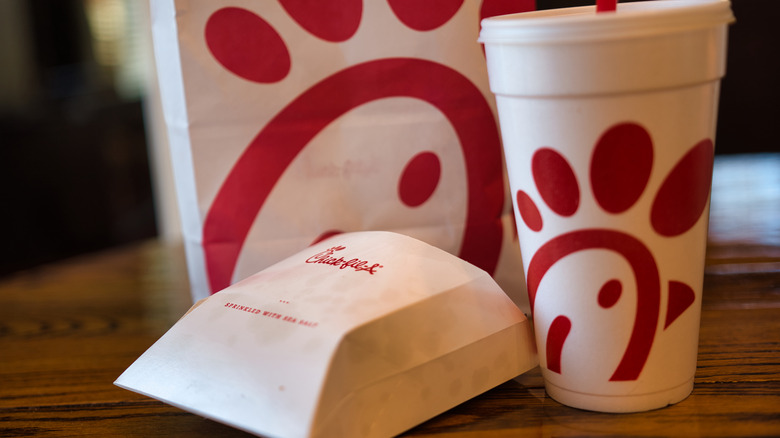 Chick-fil-A sandwich and drink cup on a table