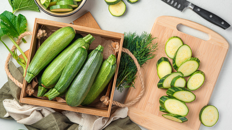 zucchini in box and sliced on board