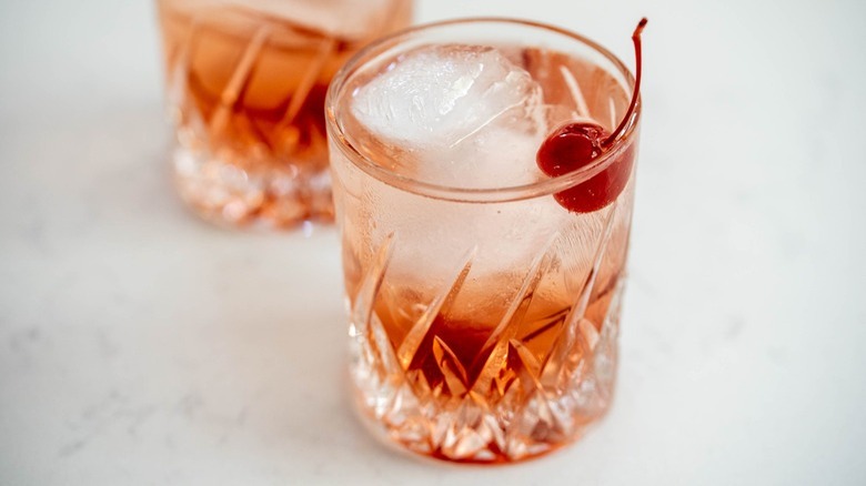 pink drink with maraschino garnish