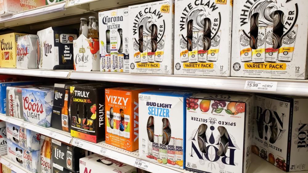 Shelf stocked with different beers and hard seltzers