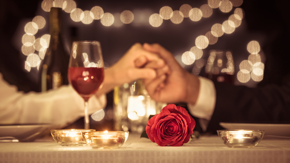 A couple holding hands on a date night