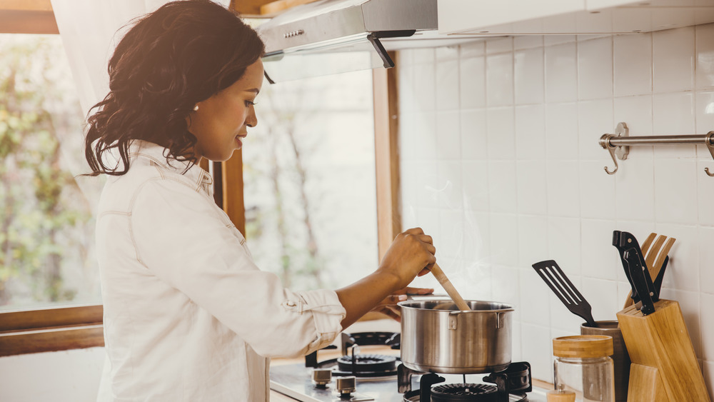 Woman cooking on stove