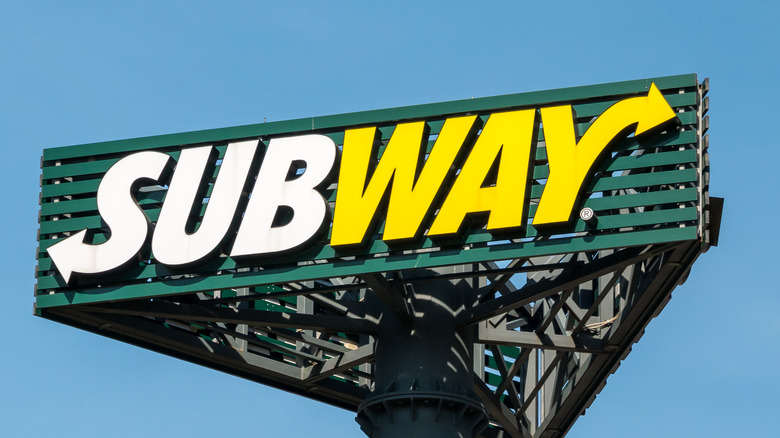 Subway sign with blue sky