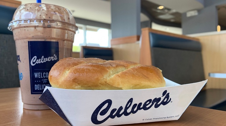 Culver's sandwich and chocolate milkshake on indoor restaurant table