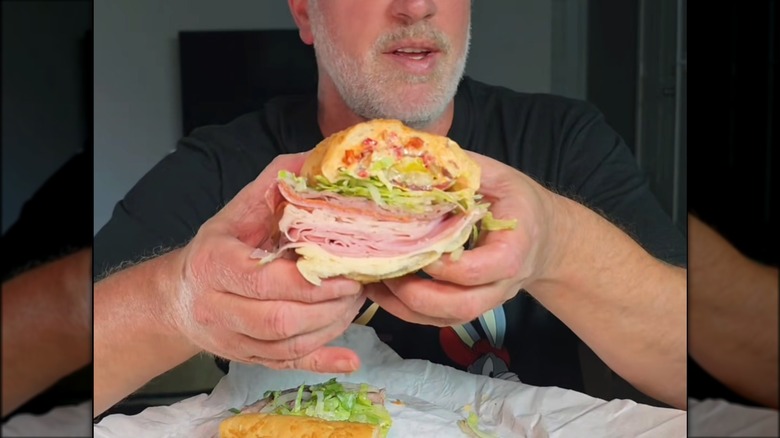 Hands holding the 'Kitchen Sink' sub from Jersey Mike's