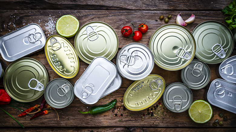 Overhead view of assorted cans on wooden surface