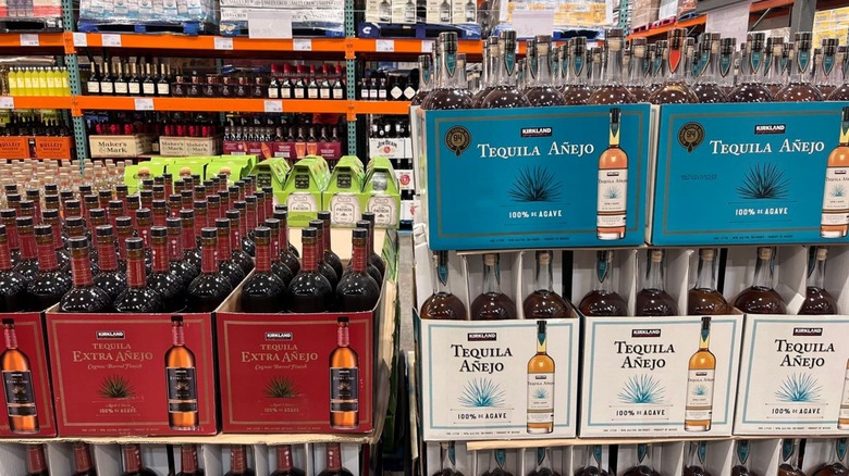 Three varieties of Kirkland Signature tequila inside a Costco warehouse.