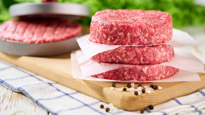 Stacked raw hamburger patties