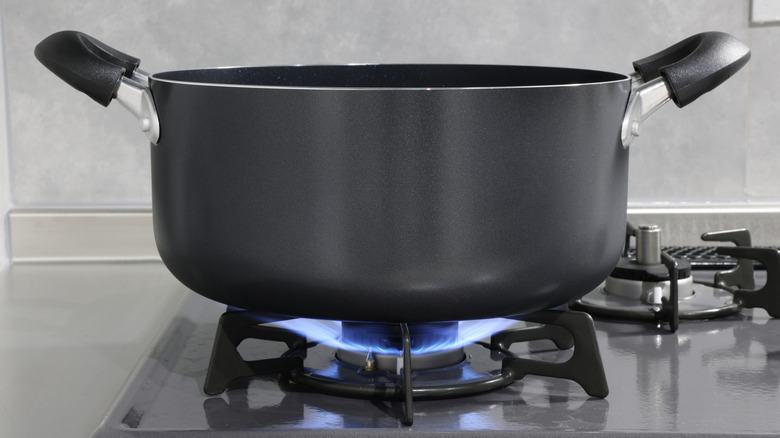 Large black pot sitting on gas burner