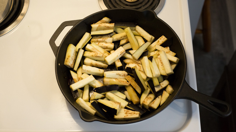 eggplant sticks cooking in pan