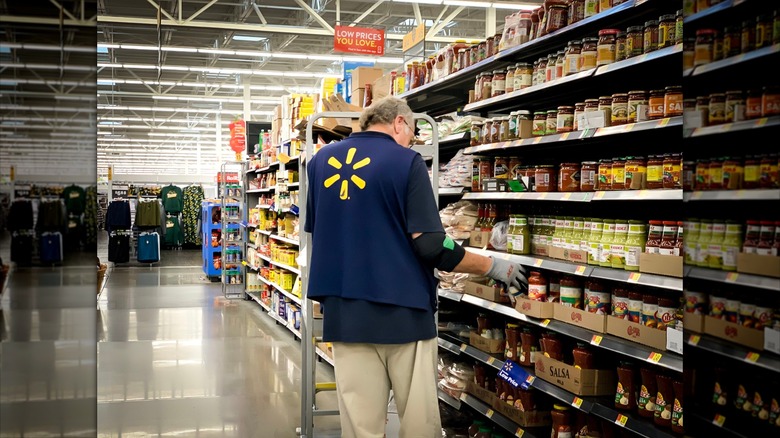 Walmart employee stocking shelves in the store