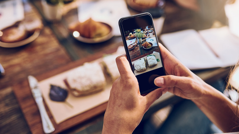 Person taking photo of food