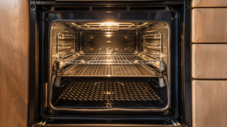 Interior of black metal oven with door open in kitchen