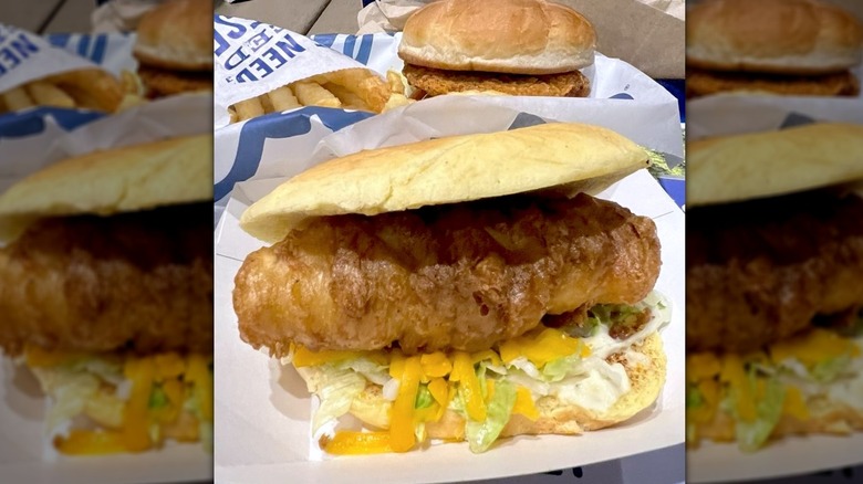 Culver's North Atlantic Cod Sandwich extra crispy with cheese and lettuce showing and fries and chicken sandwich in background