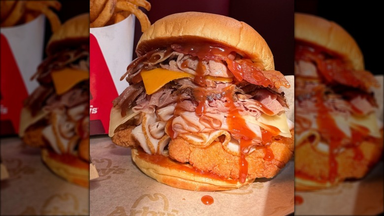 Arby's sandwich piled high with roast beef, turkey, bacon, and chicken.