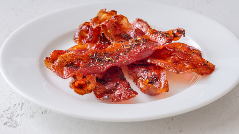 Crispy bacon strips on small white plate