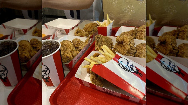 An assortment of chicken, plus fries and beverage, on tray at KFC.