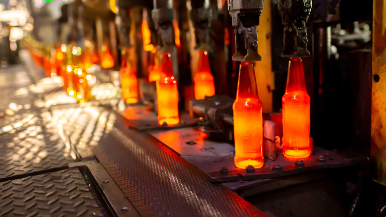 Glass bottle making assembly line.