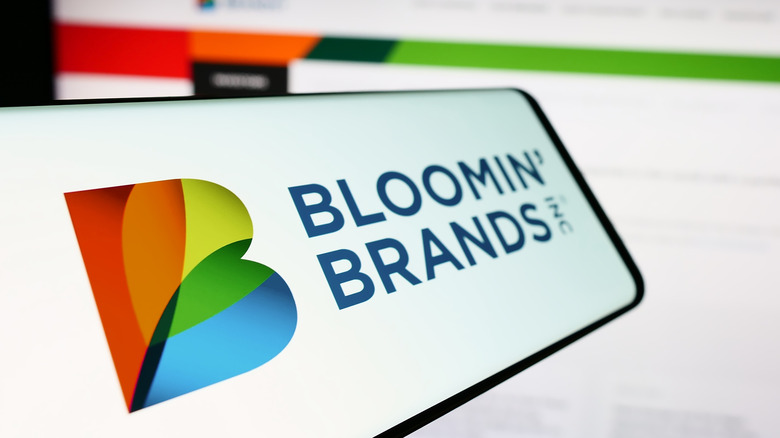 smartphone with Bloomin' Brands logo on the screen