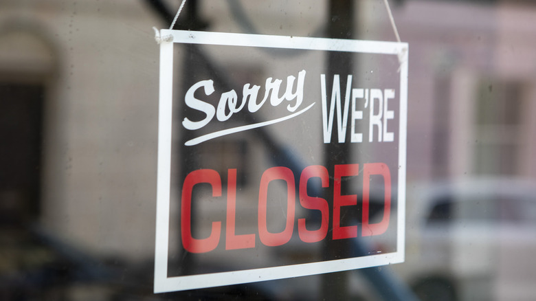 sorry we're closed signage on shop window