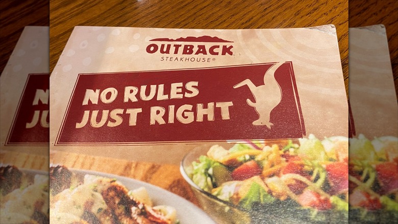 outback steakhouse menu on table in restaurant