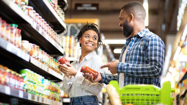 happy couple shopping in grocery store