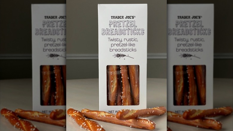 Box of pretzel breadsticks with some loose sticks