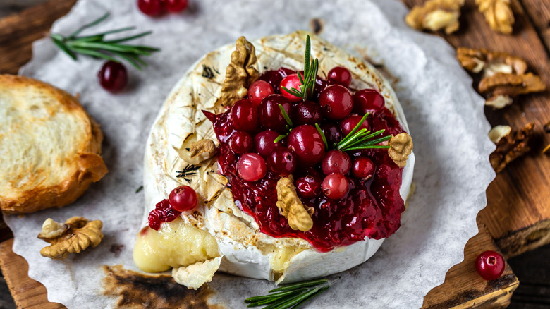 Melty brie wheel topped with cranberries and rosemary.