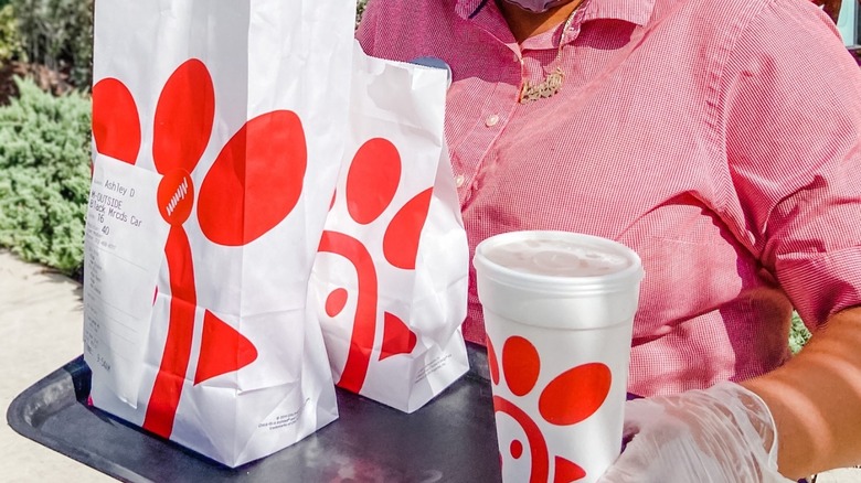 Person carrying a Chick-fil-A meal