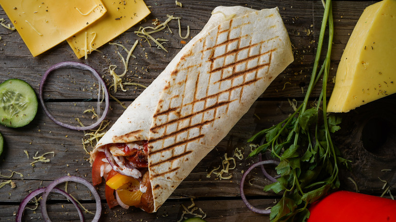 A burrito on a wooden table