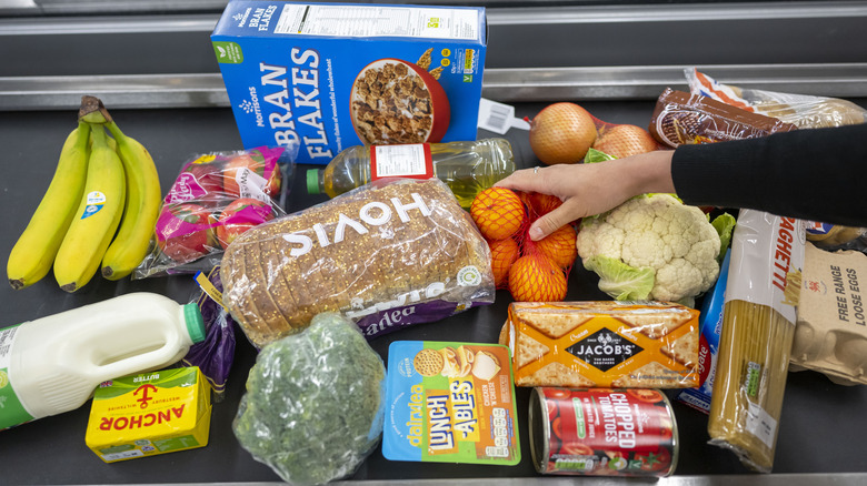 Various grocery items on a convenyor belt