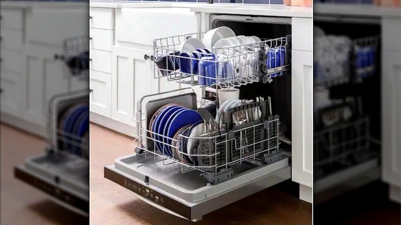 Inside of a GE 24-inch Built-in Tall Tub Top Control Dishwasher holding plates and dishes