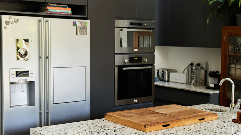 A kitchen with a fridge and double oven