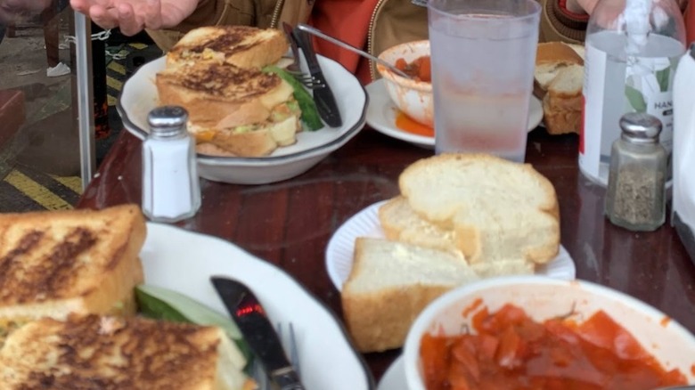 A table with tuna melts and bowls of borscht at B&H Dairy