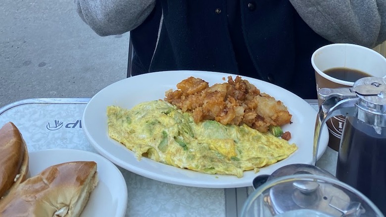 A plate with an avocado omelet and hash browns from La Bonbonierre in Manhattan