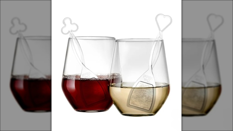 Two glasses containing wine and special purifying wands