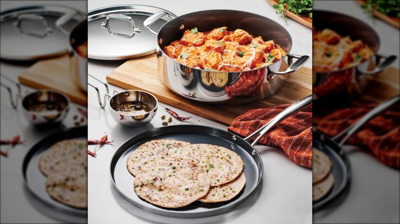Shallow skillet with flatbread and casserole dish with chicken