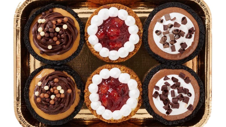 A tray with six mini pies in various flavors.