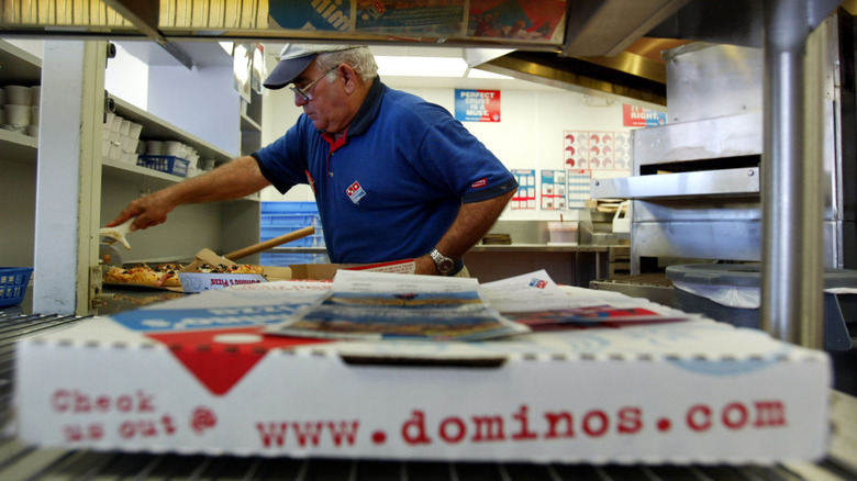 Dominos employee with pizza box