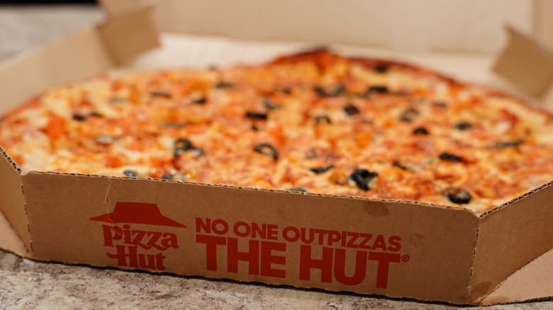 Open Pizza Hut box with pizza inside
