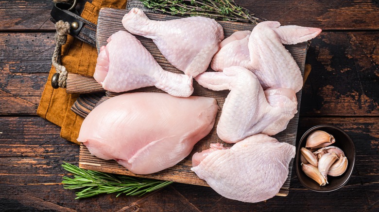 Chicken parts on wooden board