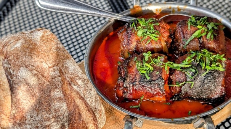 A hunk of bread and chorizo-stuffed medjool dates with spoon