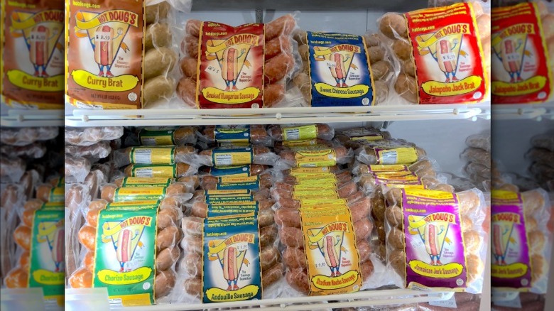 Various packages of Hot Doug's sausages in store cooler.