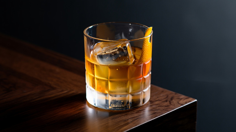 Old fashioned cocktail on table