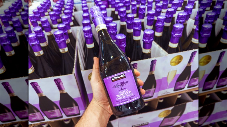 person holding bottle of Kirkland Prosecco