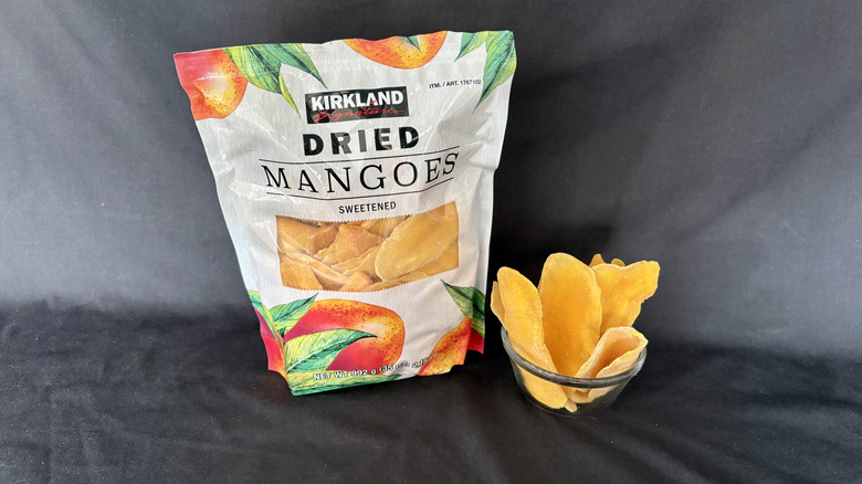 dried mangos bag behind bowl of dried mangos