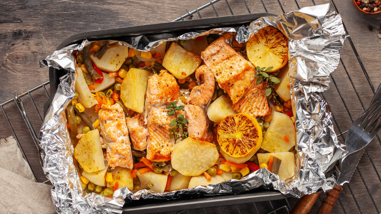 A salmon and potato medley inside silver foil.