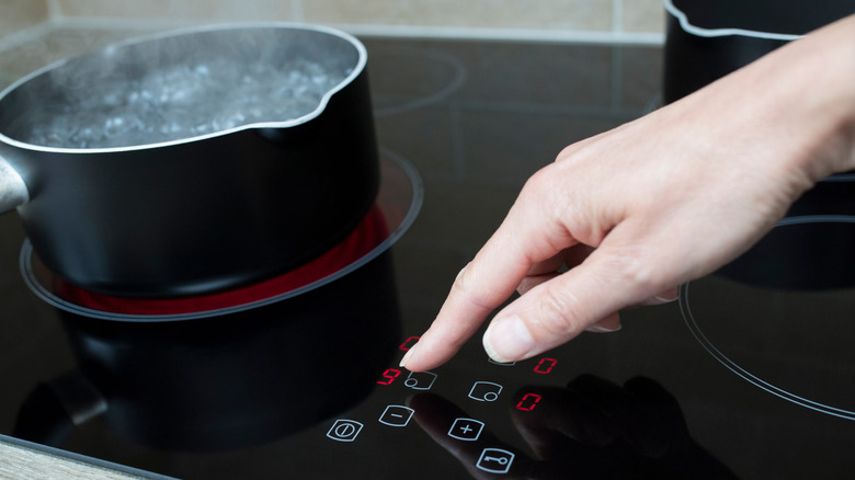 Person using an induction stovetop